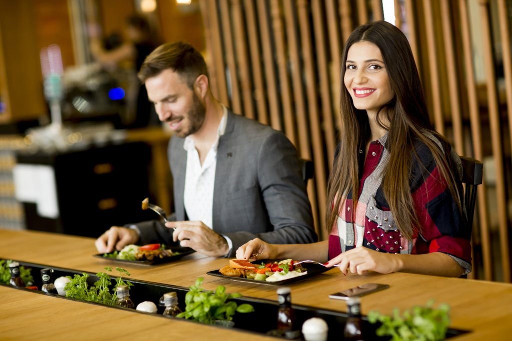 Young loving couple having lunch in the modern restaurant