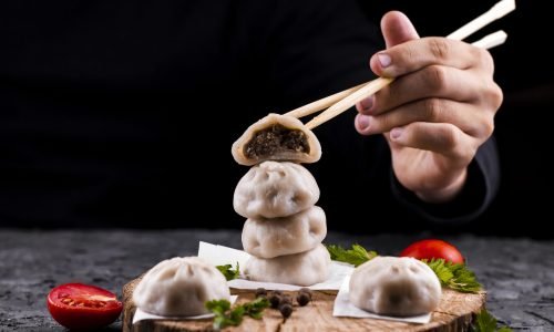 hand-holding-chopsticks-with-dumpling